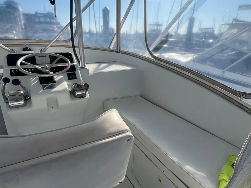 Slide: The Image of 1995 Luhrs Tournament 290 Open boat helm with steering wheel and controls. - 6