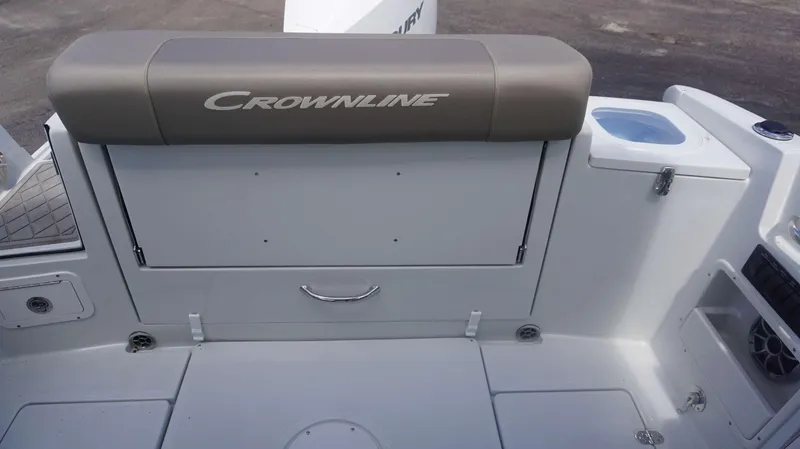 Slide: The Image of 2024 Crownline 240 DC boat interior with cushioned seating and storage compartments. - 13