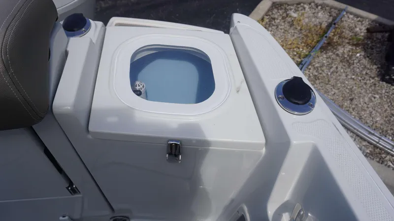 Slide: The Image of 2024 Crownline 240 DC boat livewell with seating and cup holders. - 14