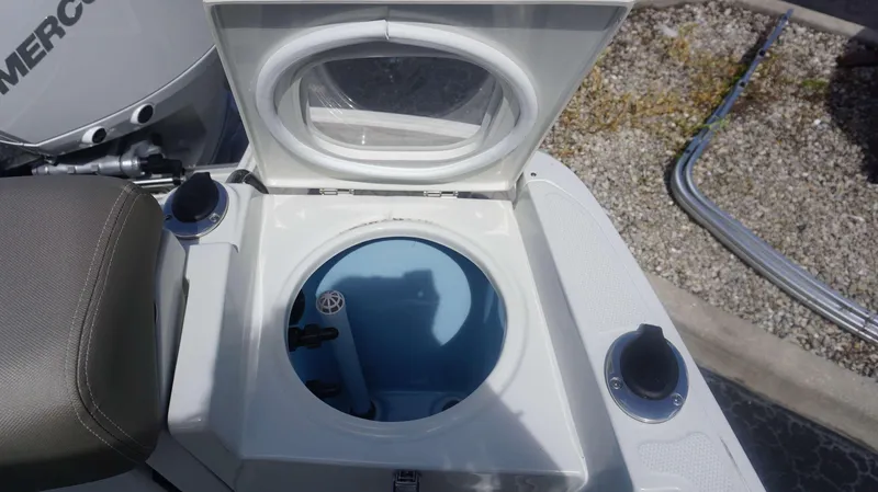 Slide: The Image of 2024 Crownline 240 DC boat livewell with open lid, showcasing interior features. - 15