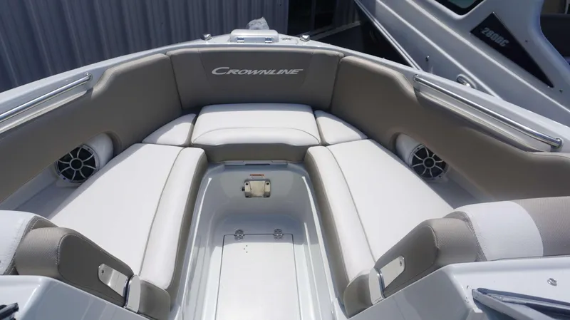 Slide: The Image of 2024 Crownline 240 DC boat interior with cushioned seating and speakers. - 4