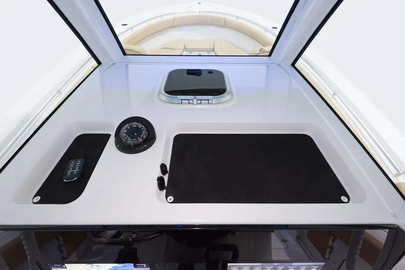 Slide: The Image of 2026 Sportsman Open 302 Center Console interior with speakers and palm tree view. - 12