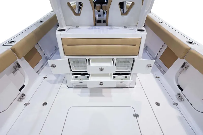 Slide: The Image of 2026 Sportsman Open 302 Center Console boat interior with white seating and speakers. - 14
