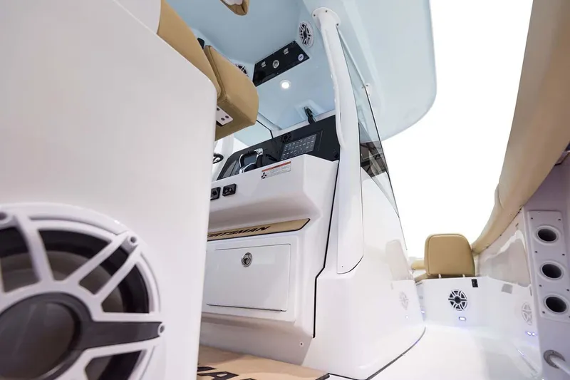 Slide: The Image of 2026 Sportsman Open 302 Center Console with open storage compartment and cushioned seating. - 16