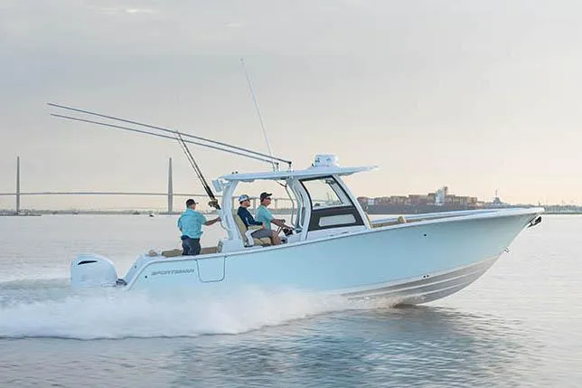 Slide: The Image of 2026 Sportsman Open 302 Center Console boat, spacious deck, modern design, docked outdoors. - 3