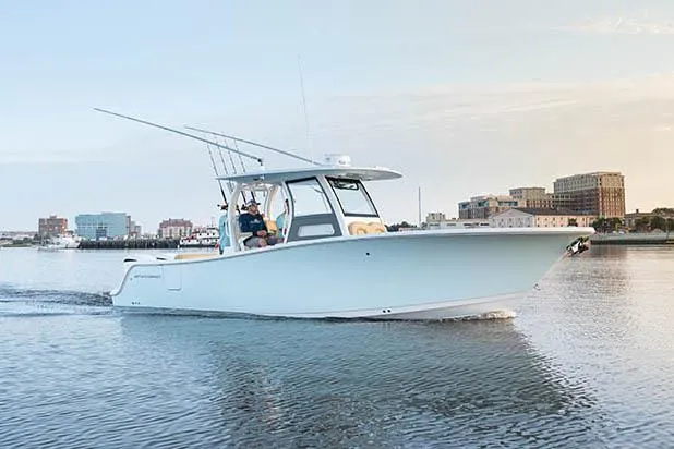 Slide: The Image of 2026 Sportsman Open 302 Center Console boat, sleek design, spacious deck, sunny day. - 6