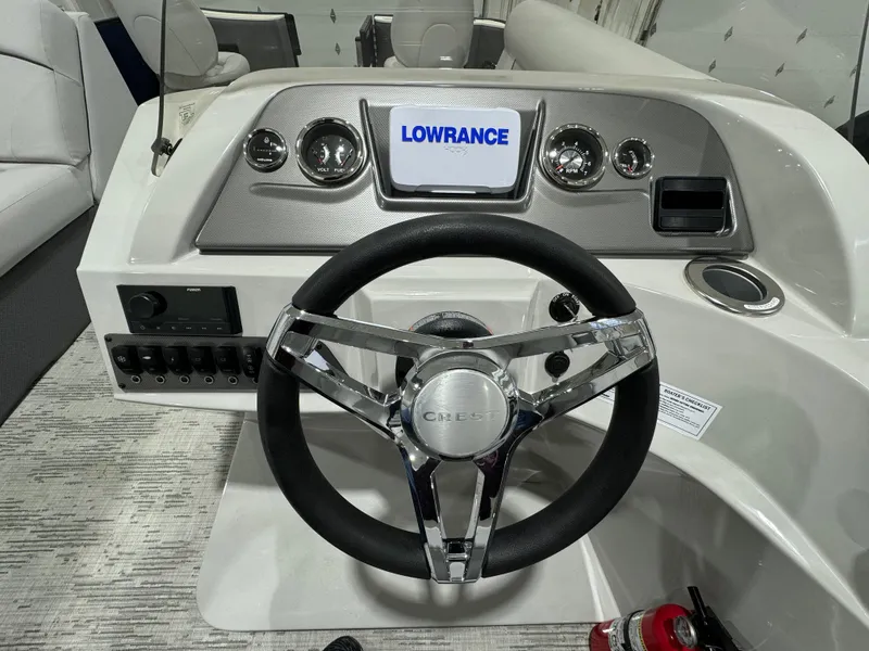 Slide: The Image of 2024 Crest Classic LX 200 boat dashboard with Lowrance display and steering wheel. - 11