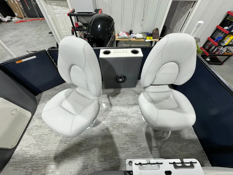 Slide: The Image of 2024 Crest Classic LX 200 boat interior with two white seats and a central console. - 14