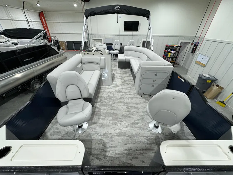 Slide: The Image of 2024 Crest Classic LX 200 pontoon boat interior with plush seating and modern design. - 5