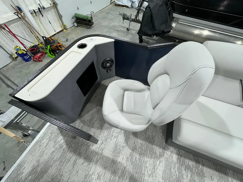 Slide: The Image of 2024 Crest Classic LX 200 boat interior with plush seating and control panel. - 7
