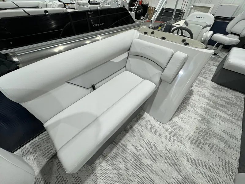 Slide: The Image of 2024 Crest Classic LX 200 boat interior with plush seating and modern design. - 8