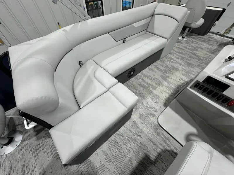 Slide: The Image of 2024 Crest Classic LX 200 boat interior with plush gray seating. - 9
