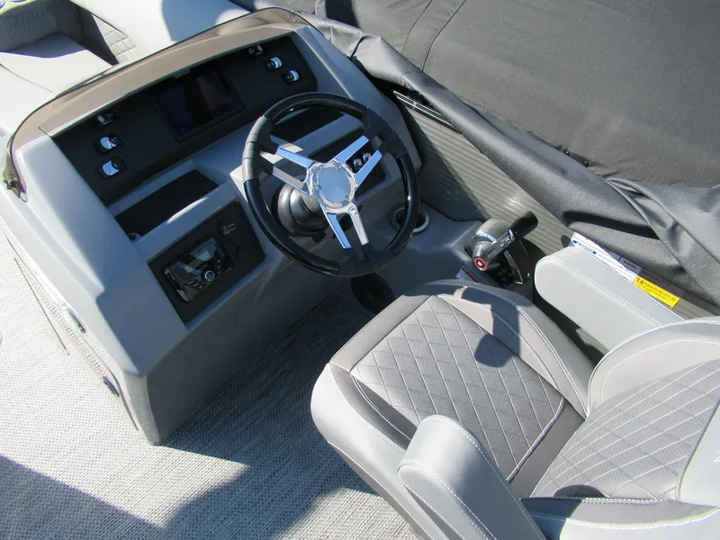 Slide: The Image of 2024 Bennington 25 LSB boat interior with steering wheel and captain's seat. - 2