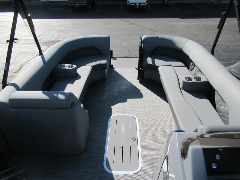 Slide: The Image of 2024 Bennington 25 LSB boat interior with gray seating and cup holders. - 3