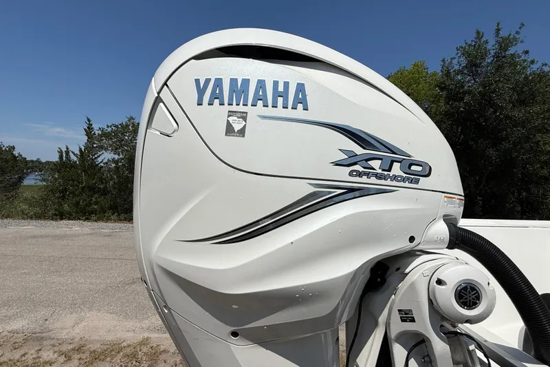 Slide: The Image of Yamaha XTO Offshore engine on 2023 Regulator 26XO boat, parked outdoors. - 13