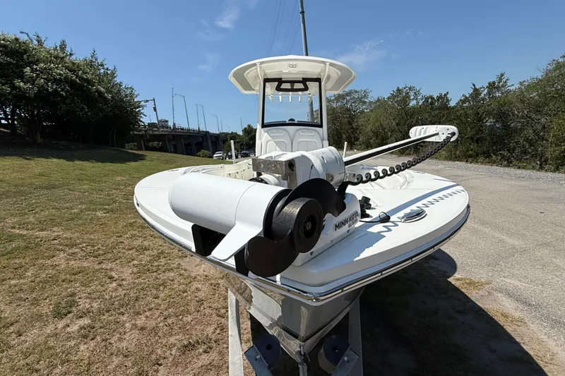 Slide: The Image of 2023 Regulator 26XO boat with Minn Kota trolling motor on a sunny day. - 8