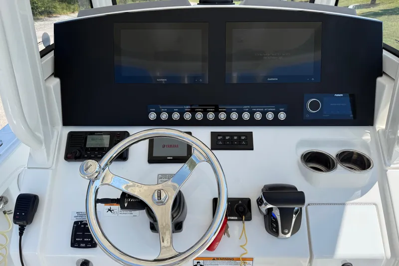 Slide: The Image of 2023 Regulator 26XO boat dashboard with dual Garmin displays and Yamaha controls. - 15