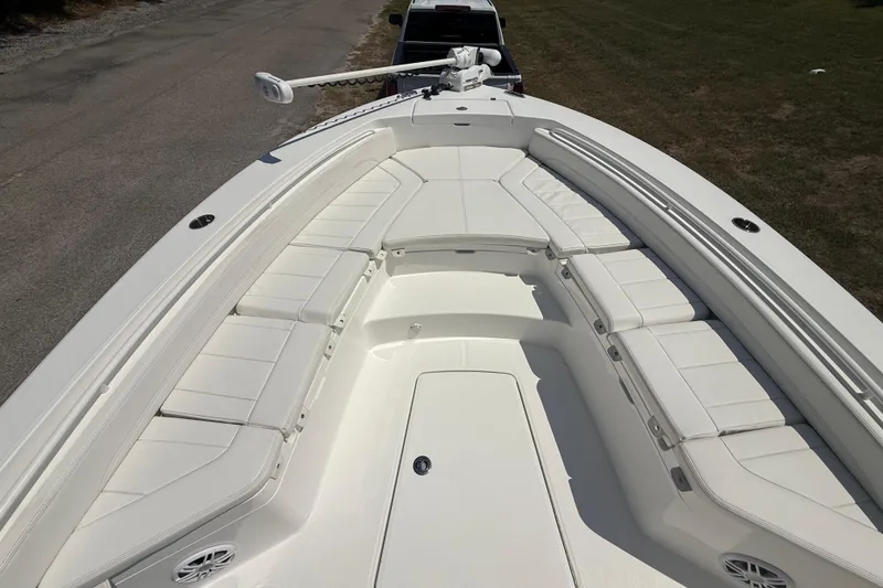 Slide: The Image of 2023 Regulator 26XO boat with spacious white seating and sleek design. - 34