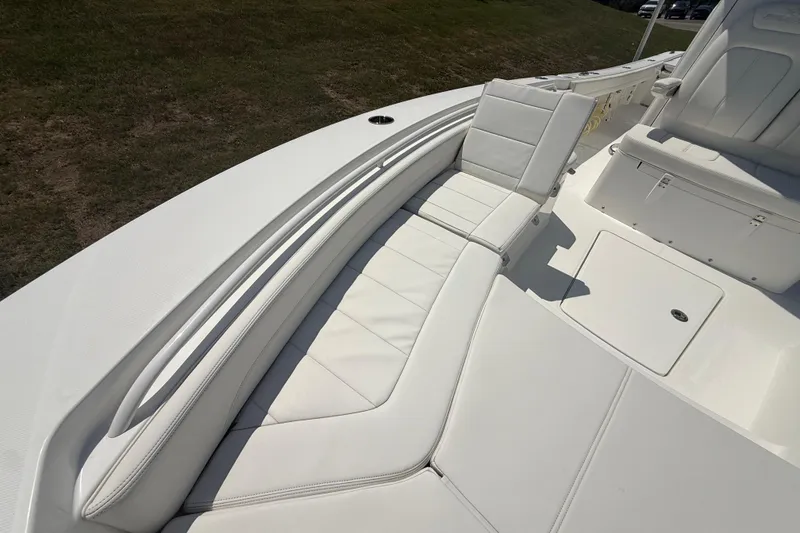 Slide: The Image of 2023 Regulator 26XO boat interior with white cushioned seating and storage compartments. - 37