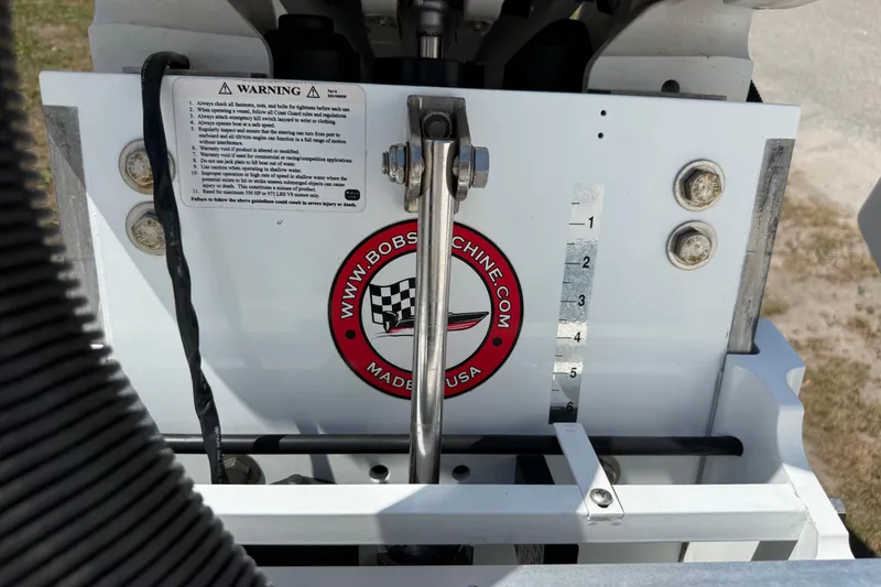 Slide: The Image of 2023 Regulator 26XO boat engine component with warning label and Bob's Machine logo. - 50