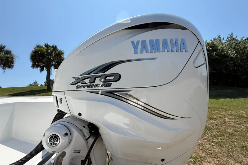 Slide: The Image of Yamaha XTO Offshore engine on 2023 Regulator 26XO boat, sunny outdoor setting. - 14