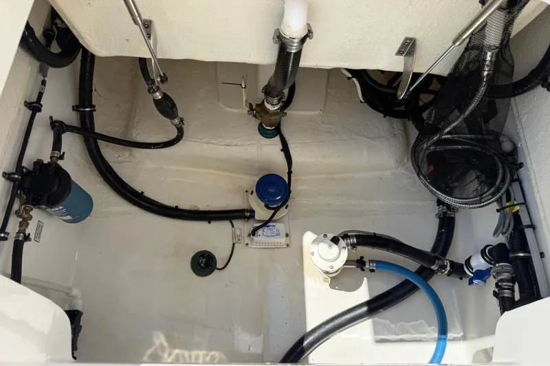 Slide: The Image of 2023 Regulator 26XO boat interior showing plumbing and wiring components. - 46