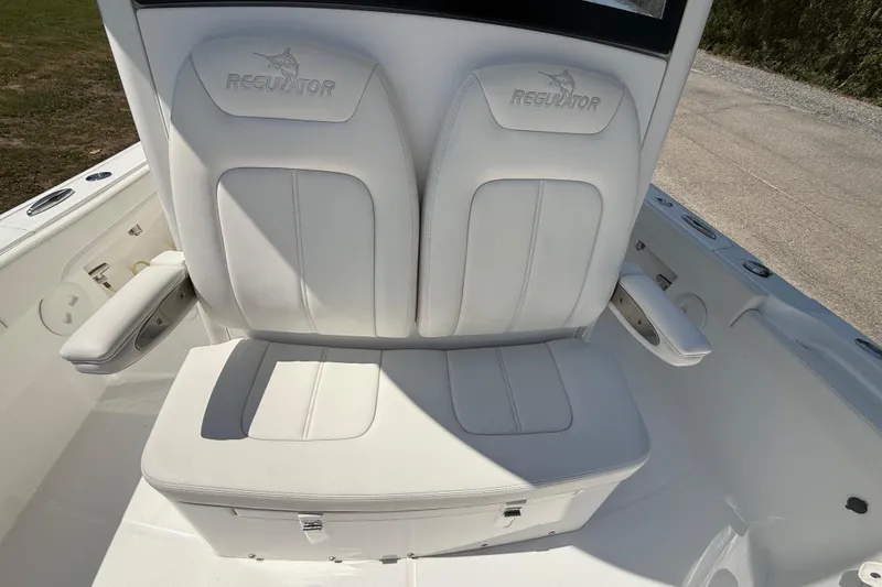 Slide: The Image of 2023 Regulator 26XO boat seating with white cushioned seats and armrests. - 33