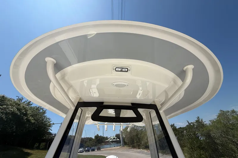 Slide: The Image of 2023 Regulator 26XO boat's T-top viewed from below against clear blue sky. - 30