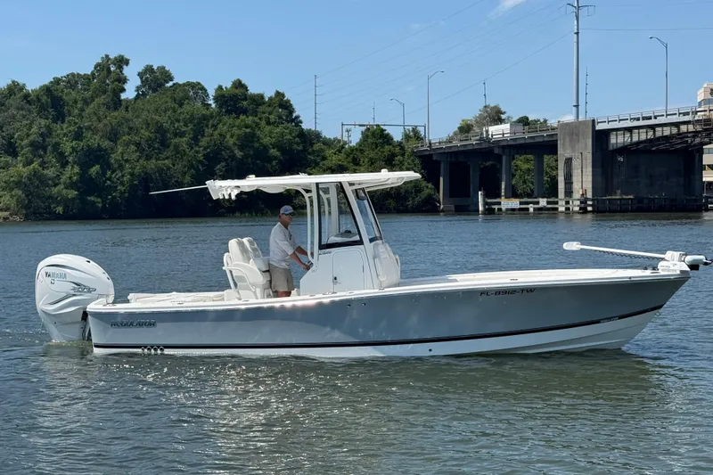 The Image of 2023 Regulator 26XO boat on water near a bridge, featuring a Yamaha outboard motor. - 0