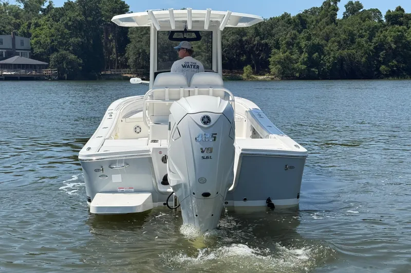 Slide: The Image of 2023 Regulator 26XO boat on water, rear view with outboard motor. - 5