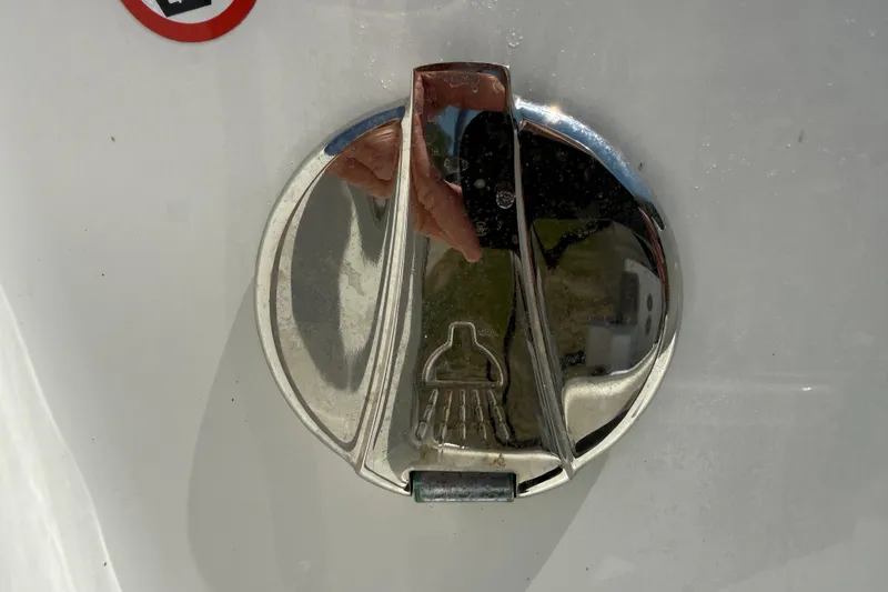Slide: The Image of Chrome fuel cap on 2023 Regulator 26XO boat, reflecting surroundings. - 49
