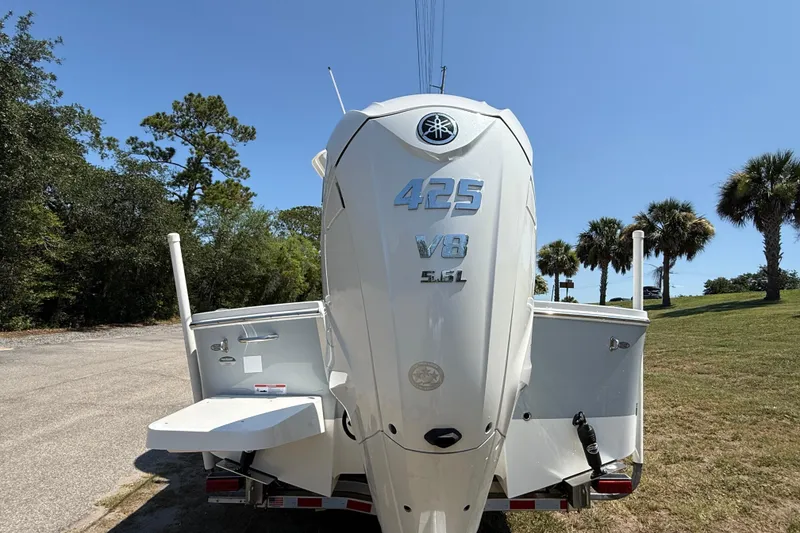 Slide: The Image of 2023 Regulator 26XO boat with Yamaha 425 V8 engine, parked outdoors. - 11