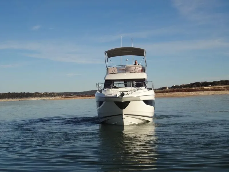 Slide: The Image of 2024 Prestige 420F yacht cruising on a calm lake. - 10