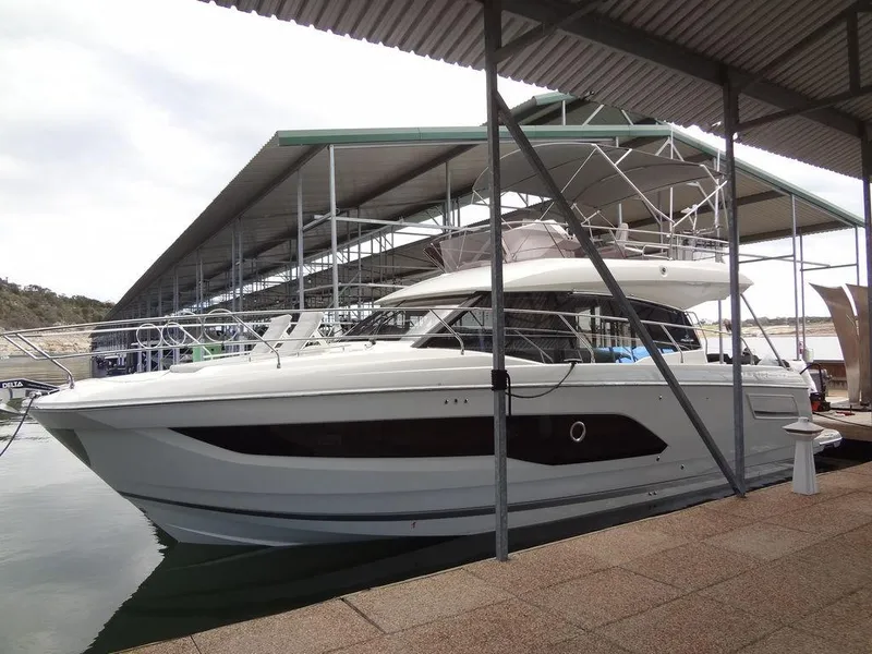 Slide: The Image of 2024 Prestige 420F yacht docked at a marina under a covered slip. - 12