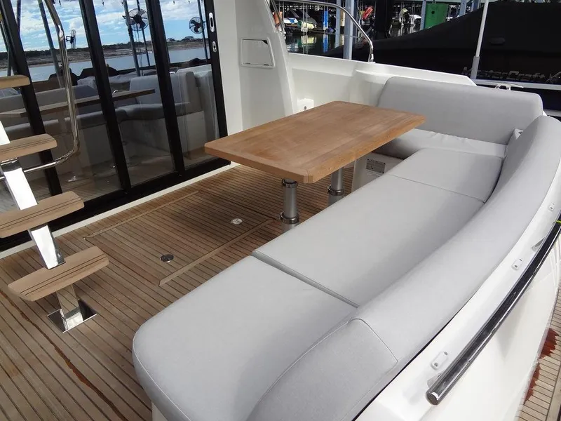 Slide: The Image of Prestige 420F 2024 yacht deck with seating area and wooden table. - 15