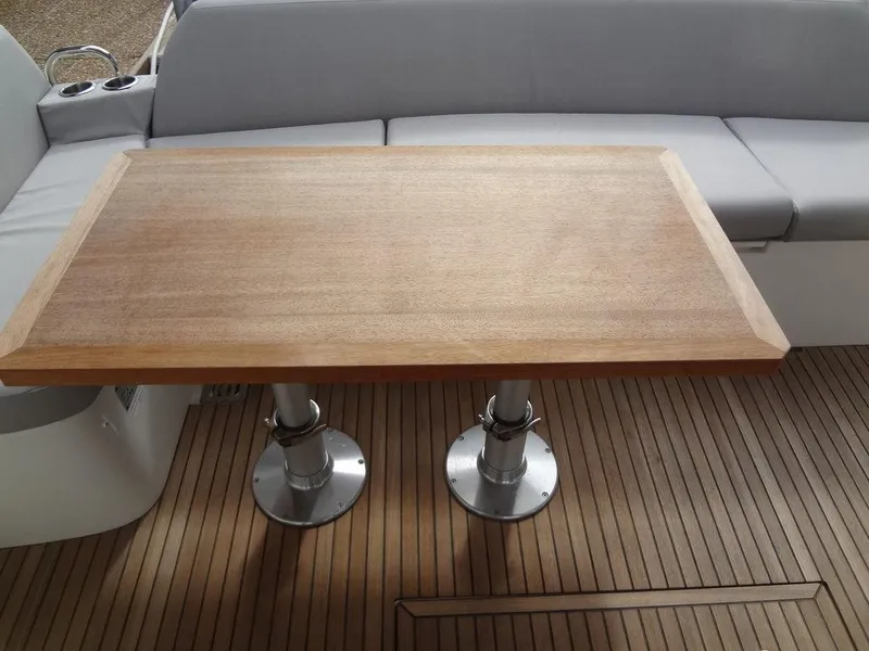 Slide: The Image of Prestige 420F 2024 yacht interior with wooden table and cushioned seating. - 17