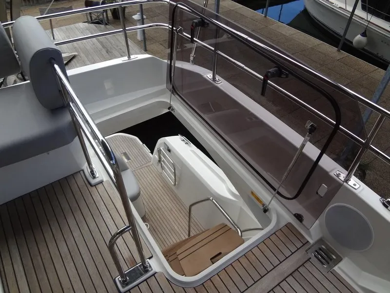 Slide: The Image of 2024 Prestige 420F yacht with teak deck and stainless steel railings. - 27