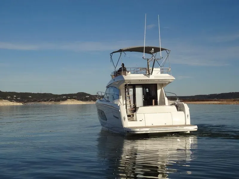 Slide: The Image of 2024 Prestige 420F yacht cruising on a calm lake. - 3