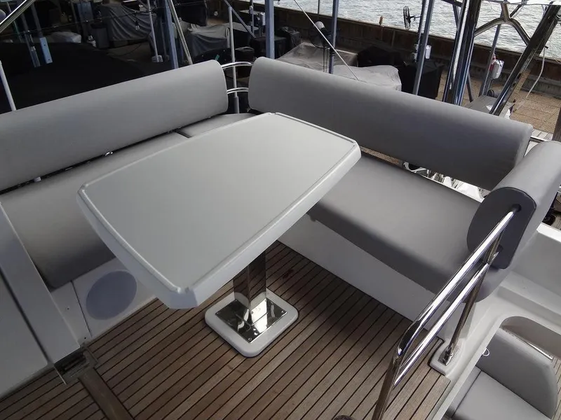 Slide: The Image of 2024 Prestige 420F yacht, outdoor seating area with a sleek table and cushioned benches. - 33