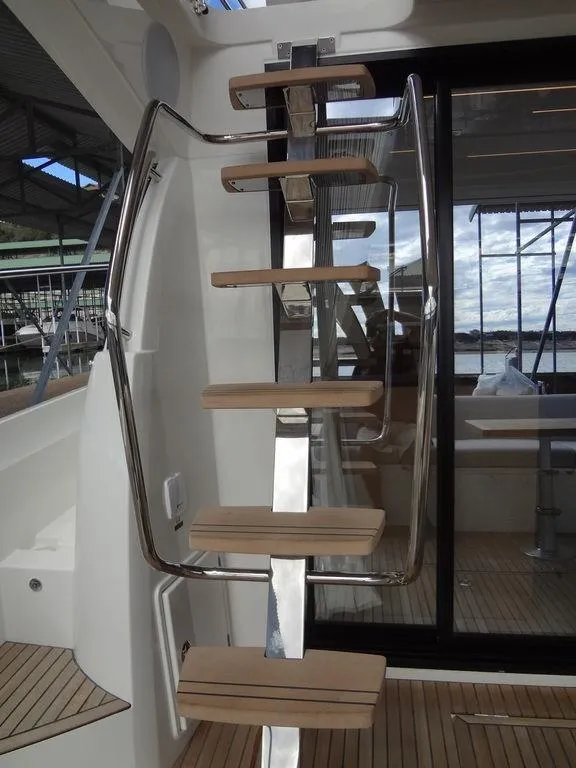 Slide: The Image of Prestige 420F 2024 yacht interior staircase with wooden steps and metal railings. - 35