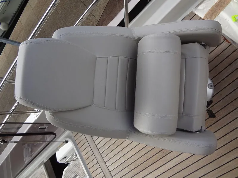 Slide: The Image of 2024 Prestige 420F boat's luxurious gray captain's chair on teak deck - 40