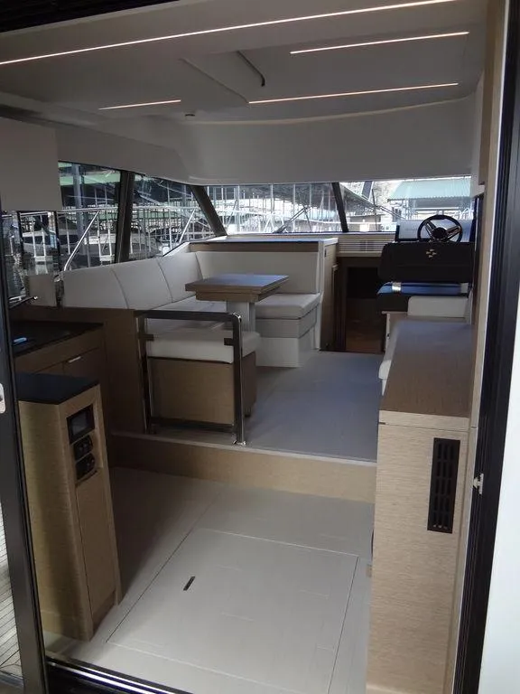 Slide: The Image of 2024 Prestige 420F yacht interior with modern seating and helm station. - 43