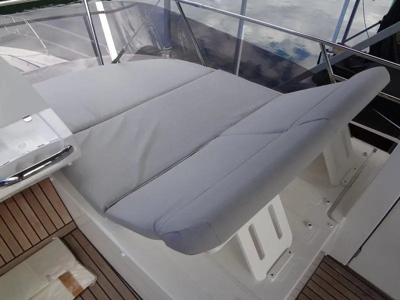 Slide: The Image of 2024 Prestige 420F yacht with cushioned seating area on deck. - 49
