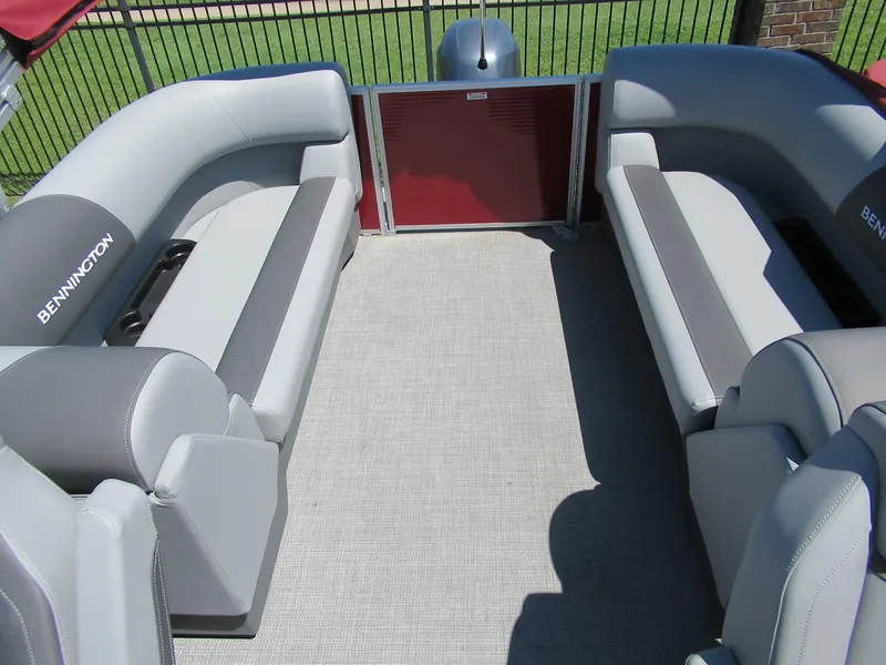 Slide: The Image of 2024 Bennington 22 SVSR pontoon boat interior with gray seating and red accents. - 5