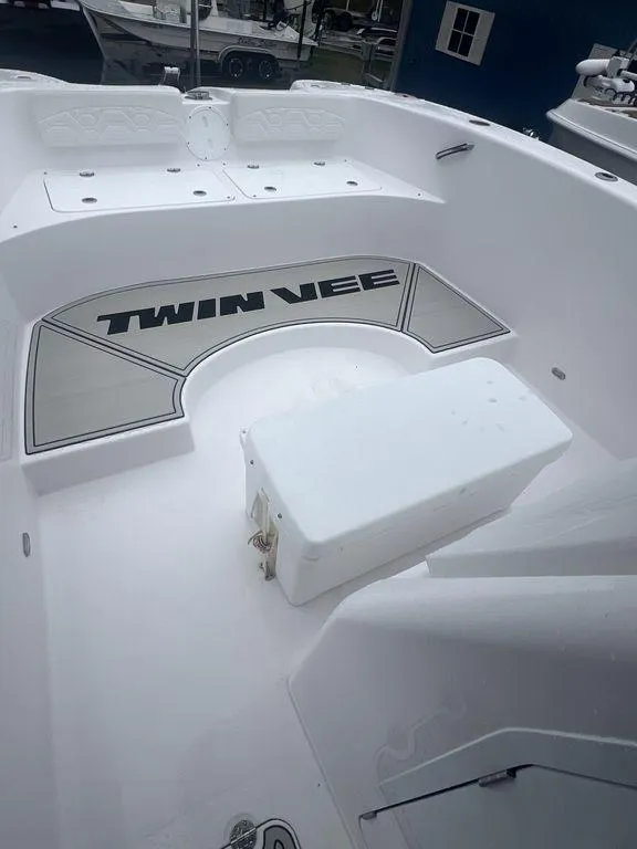Slide: The Image of 2024 Twin Vee 280 STX boat interior with seating and branding. - 10