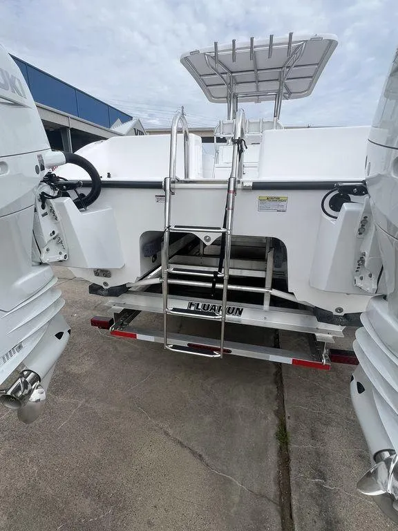 Slide: The Image of 2024 Twin Vee 280 STX boat with dual engines and rear ladder. - 17