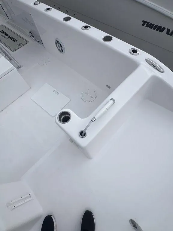 Slide: The Image of 2024 Twin Vee 280 STX boat deck with rod holders and storage compartments. - 18