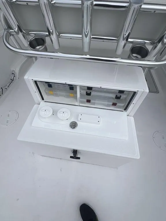 Slide: The Image of 2024 Twin Vee 280 STX boat console with controls and storage compartments. - 20