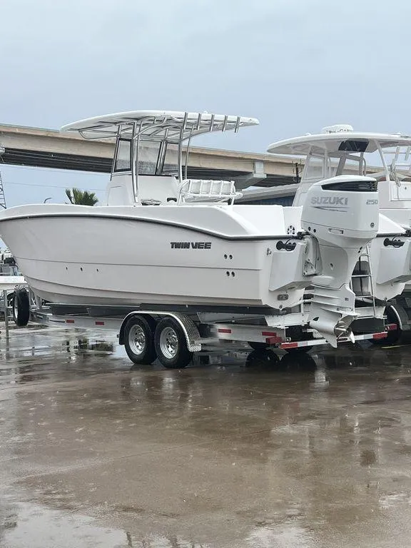 Slide: The Image of 2024 Twin Vee 280 STX boat on trailer, featuring dual Suzuki outboard engines. - 4