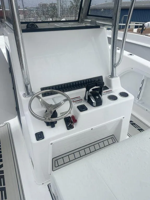 Slide: The Image of 2024 Twin Vee 280 STX boat console with steering wheel and controls. - 5